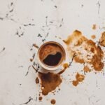 A top view of a Turkish coffee cup with spills on a marble surface, capturing the traditional beverage's essence.