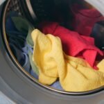Vibrant close-up of multicolored towels inside a washing machine, ready for a wash.