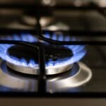 A detailed view of a blue flame on a stove, showcasing energy and heat.