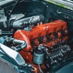 Detailed view of a vibrant engine in a classic car, showcasing retro mechanics.