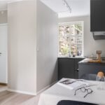 A sleek modern kitchen with minimalistic design and natural lighting.
