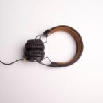 Minimalist image of black over-ear headphones on a white background.