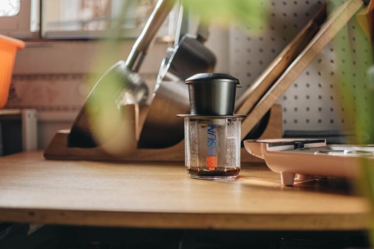 A cozy kitchen featuring a coffee maker and kitchen tools on a wooden counter, emphasizing a warm home vibe.