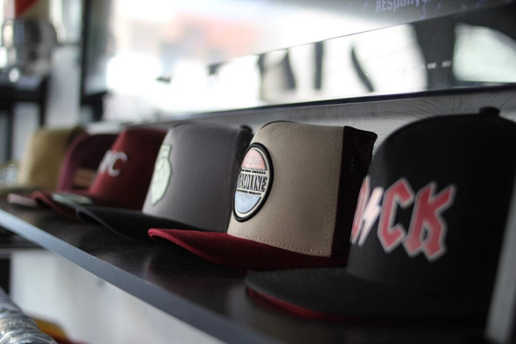 Collection of trendy baseball caps arranged on a store shelf, showcasing different designs.