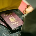 A close-up shot of Filipino passports at the airport, indicating travel and identity.