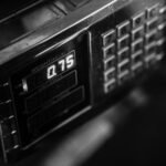 Close-up of a digital weight scale in black and white, showcasing measurement settings.