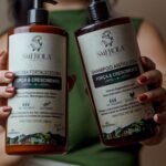 Close-up of Smerola hair care bottles focusing on growth and strength benefits.