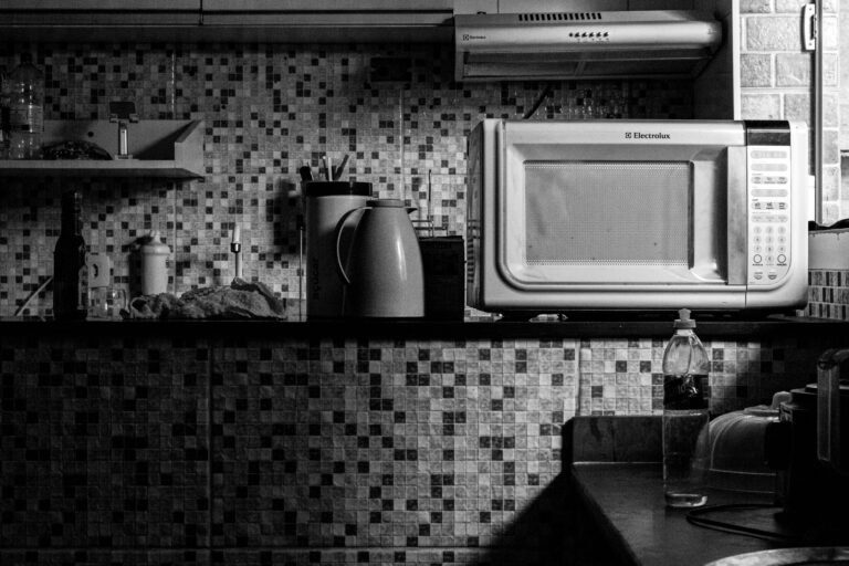 Black and white kitchen scene featuring an Electrolux microwave and various kitchen items, perfect for domestic lifestyle themes.