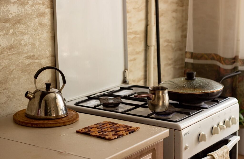 A traditional kitchen stove with a kettle and pan, creating a warm, homey ambiance.