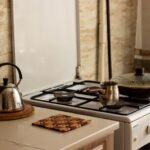 A traditional kitchen stove with a kettle and pan, creating a warm, homey ambiance.