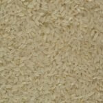 Close-up of uncooked white rice grains showing texture and detail, ideal for culinary themes.