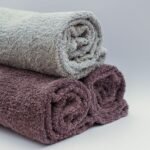 Close-up of rolled bathroom towels in neutral tones, ideal for interior design or spa themes.