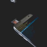 Close-up of a smartphone displaying Android recovery mode with an SD card inserted.