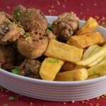 Savor a hearty plate of crispy fried chicken and golden fries garnished with herbs.