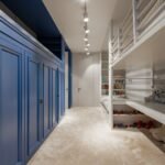 Creative design of bedroom with built in wardrobe and bed between collection of toys in light house