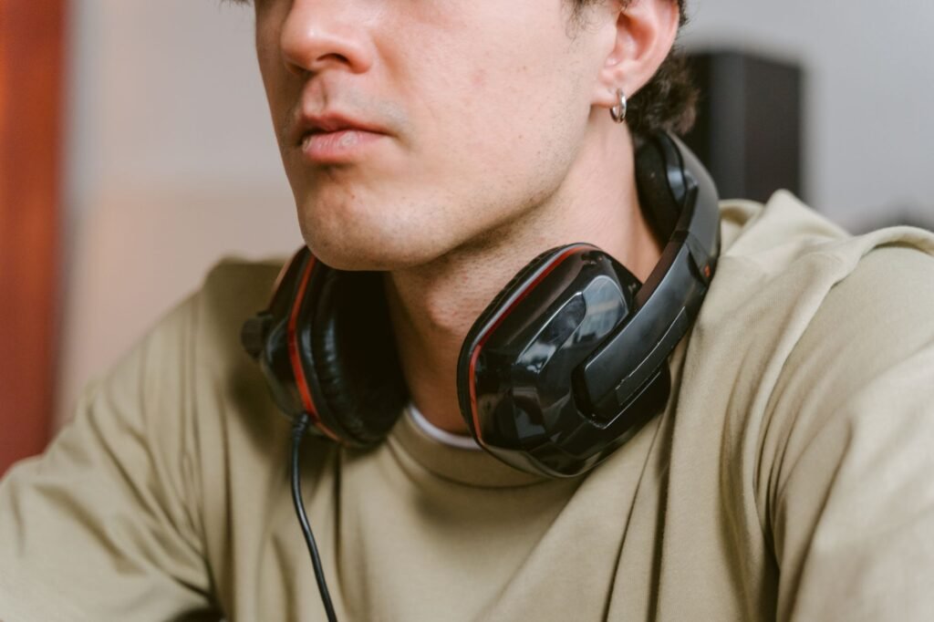 Close-up of a young man wearing a gaming headset while relaxed indoors.