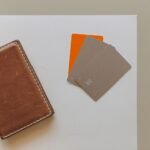 A leather wallet and credit cards on a minimalist background, ideal for financial themes.
