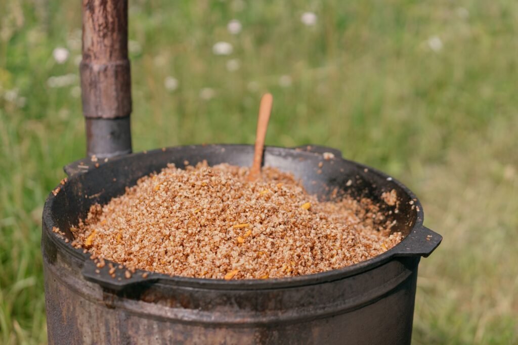 A rustic pot with cooked buckwheat groats on a sunny day outdoors, perfect for food themes.