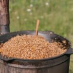 A rustic pot with cooked buckwheat groats on a sunny day outdoors, perfect for food themes.