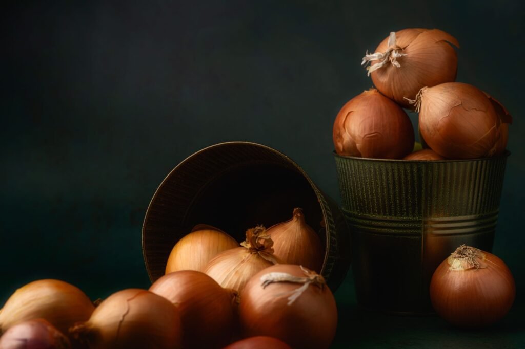 A moody still life of raw onions in rustic containers, showcasing a timeless charm.