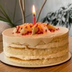 A delightful birthday cake with a lit candle, perfect for celebrations.