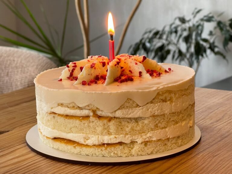 A delightful birthday cake with a lit candle, perfect for celebrations.