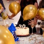 A lively 30th birthday party featuring friends, golden balloons, and a festive cake.
