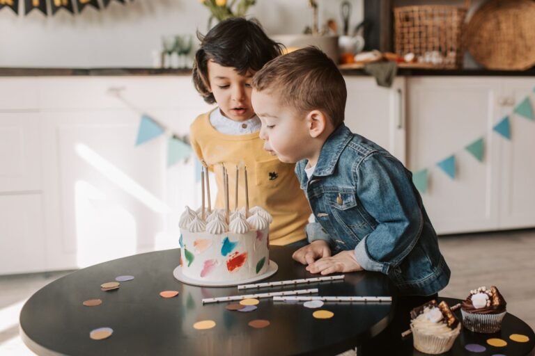 Two children enjoying a birthday celebration at home with a beautiful cake.