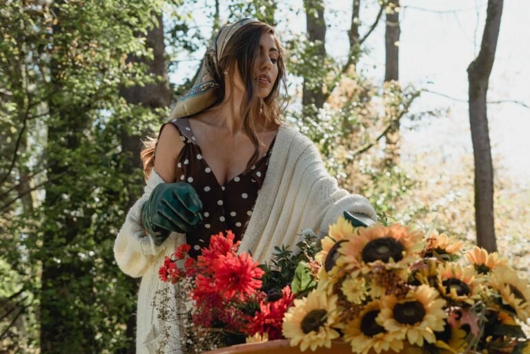 A woman in a polka dot dress harvests sunflowers in a sunlight-dappled garden.
