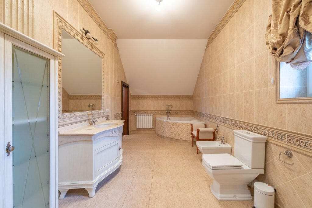 Spacious modern bathroom with contemporary design elements including a large bathtub and elegant fixtures.