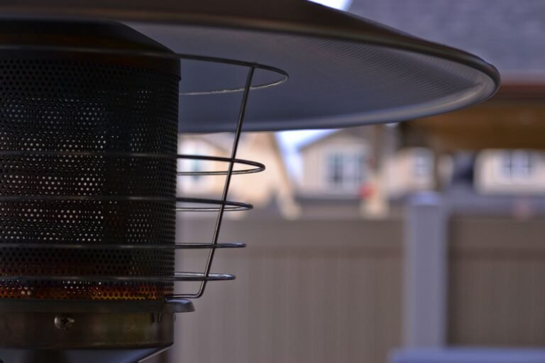 Detailed view of a modern outdoor patio heater with blurred suburban background, perfect for outdoor comfort concepts.