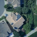 An aerial view showcasing modern suburban houses equipped with solar panels for renewable energy.