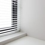 Bright minimalist interior with white window blinds and smooth wall, perfect for modern design.