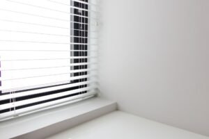 Bright minimalist interior with white window blinds and smooth wall, perfect for modern design.