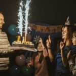 A family celebrating a birthday with a sparkling cake and joyful moments indoors.
