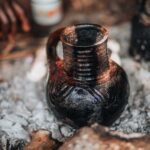 Close-up of a traditional Ethiopian stoneware pot among ashes, highlighting cultural craftsmanship.